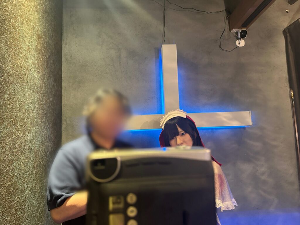 ポラロイド越しにポーズを取る客とえまさん